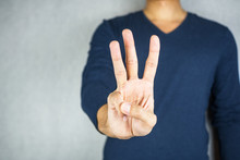 Three Finger Salute Hand Gesture, On Light Grey Background