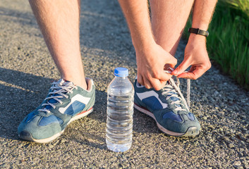 The athlete tying shoelaces close up