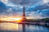 Fototapeta Boho - The Eiffel Tower at sunrise. Paris, France. Beautiful skyline of with rising sun and dramatic clouds.