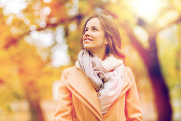 Wall Mural - beautiful happy young woman walking in autumn park