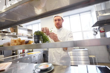 Wall Mural - happy male chef cooking at restaurant kitchen