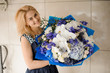 Smiling blonde girl holding a bouquet