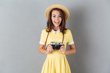 Cheerful Young Girl In Hat Holding Retro Camera