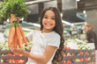 © Yakobchuk Olena - Cheerful young child holding vegetables in arms