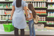 © Yakobchuk Olena - Mom and little daughter choosing dairy product