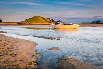 Wall Mural - Church Hill across River Aln Estuary / As the River Aln approaches the North Sea at Alnmouth, now tidal, there are several boats moored in the estuary