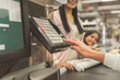 © Yakobchuk Olena - People standing near cash desk