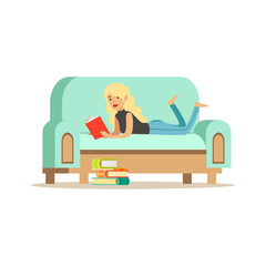 Sticker - Young blonde woman lying on her stomach on a light blue sofa and reading a book, woman resting at home vector Illustration