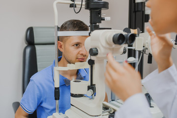 Wall Mural - Young beautiful woman doctor/eye specialist/optometrist in an ophthalmologic clinic