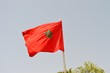Moroccan flag. The natural image of a beautiful flag on the background of the blue sky.
