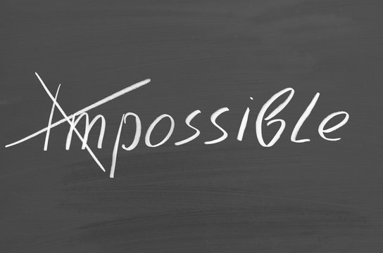 Impossible possible. Text on chalkboard