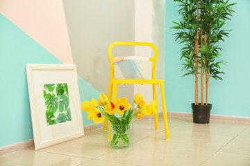 Wall Mural - Comfortable yellow chair and decorative elements near wall in modern room