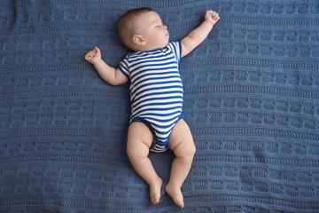 cute little baby sleeping on bed