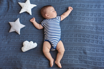 cute little baby sleeping on bed