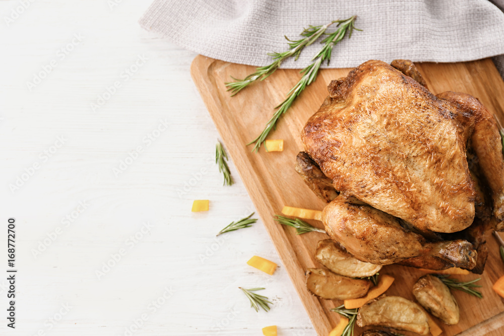 Tasty whole roasted turkey with rosemary on table