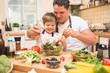 © Kirill Grekov - Chef man cooking on the kitchen with little son.