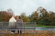© cindyprins/Stocksy - Senior couple sitting on a bench together and talking