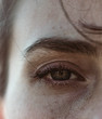 © lucapierro/Stocksy - Close up on eye of a middle age woman under sunset light