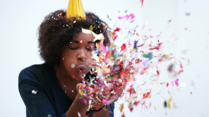 Poster - afro woman blowing confetti at party