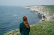 © SHOTPRIME STUDIO - Young woman on a cliff, mountains, nature, sea