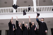 © Johnstocker - Group of Successful students with congratulations together throwing graduation hats in the air and celebrating. Education concept.