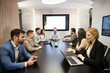 © NDABCREATIVITY - Perspective businesspeople having meeting in conference room