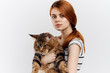 © SHOTPRIME STUDIO - Beautiful woman on a white background holds a cat, portrait, pets