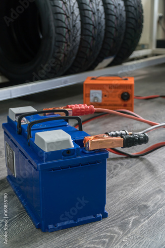 Recharging The Car Battery On A Wooden Background This Stock Recharging The Car Battery On A Wooden Background