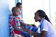 © Hugh Sitton - Nurse examing Mother and Daughter in clinic. Kenya, Africa.