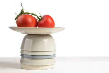 Fresh tomatoes on a plate. Red tomatoes on branch isolated on white background. Copy space