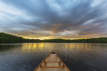 Wall Mural - Canoe bow on a Canadian lake at sunset