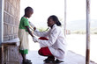 © Hugh Sitton - Female doctor examing child (female). Kenya, Africa.