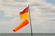 Lifeguard Flag With Windsock On Beach At Brighton, East Sussex, England