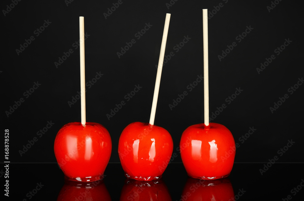 Delicious candy apples on black background