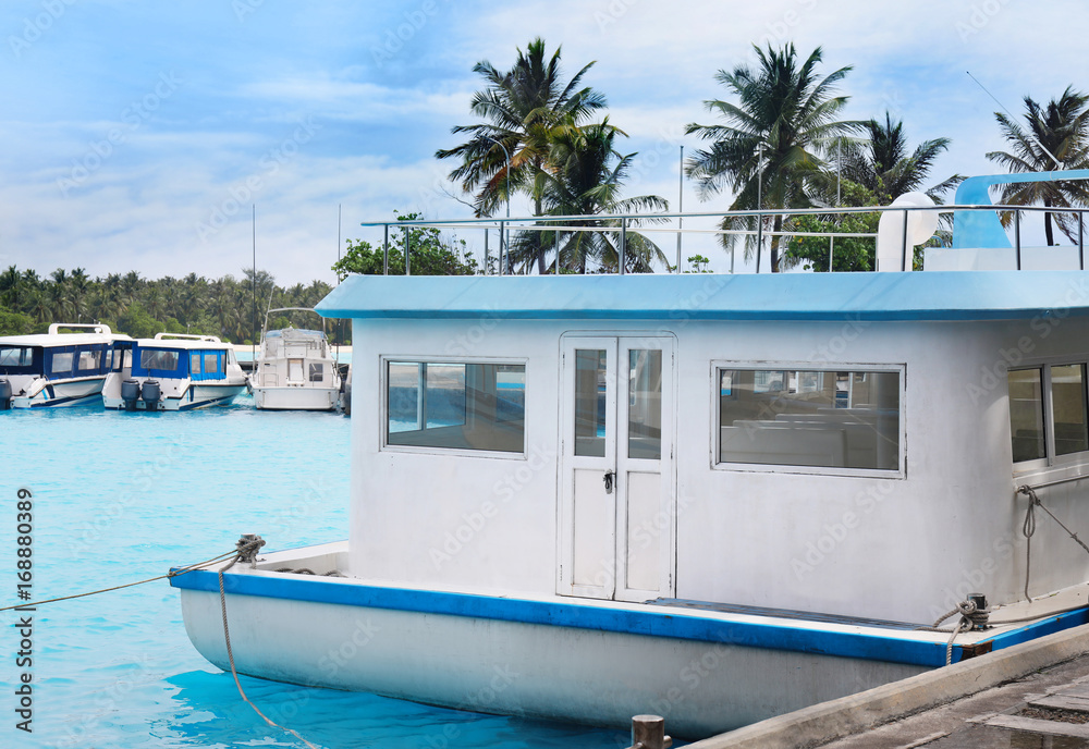 Modern boat berthed at tropical resort
