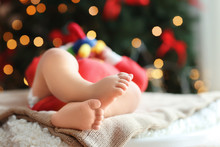 Cute Little Baby Sleeping Against Blurred Christmas Lights Background