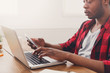 © Prostock-studio - Black businessman in casual office, work with laptop