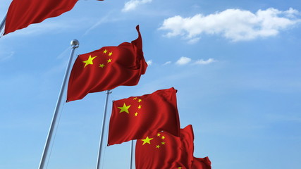 Row of waving flags of China agaist blue sky, 3D rendering