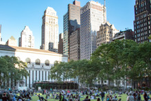Crowds Of People Gather On The Grass At Bryant Park For A Summer Festival In Midtown Manhattan On A Warm Sunny Day In New York City