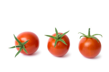 Wall Mural - three cherry tomatoes on a white background