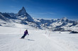 Female skier skiing on the slopes of Matterhorn mountain