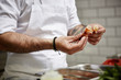 © ALTO IMAGES/Stocksy - Chef Removing Prawn Head In Commercial Kitchen