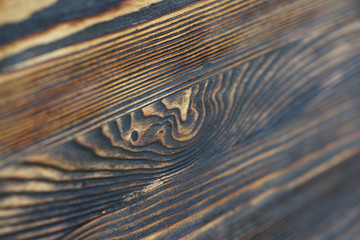 Burnt-out wood surface treated with impregnation