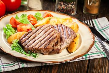 Wall Mural - Succulent portions of grilled fillet mignon served with baked potatoes