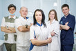 © spaskov - Group of dentists standing in their office and looking at camera.