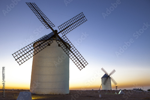 Fotografía Illuminated traditional windmills at rising