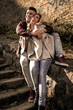 © liderina - Happy couple outdoor. Young couple sitting on stairs and having funny conversation.