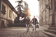 © liderina - Couple in shopping together. Young couple holding hands and running trough street.