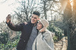 © liderina - Young couple making self-picture. Happy couple having fun in the park.