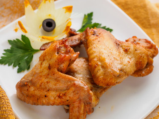 chicken wings with greens on the plate